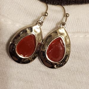 Silvertone hammered look teardrop earrings with red stones